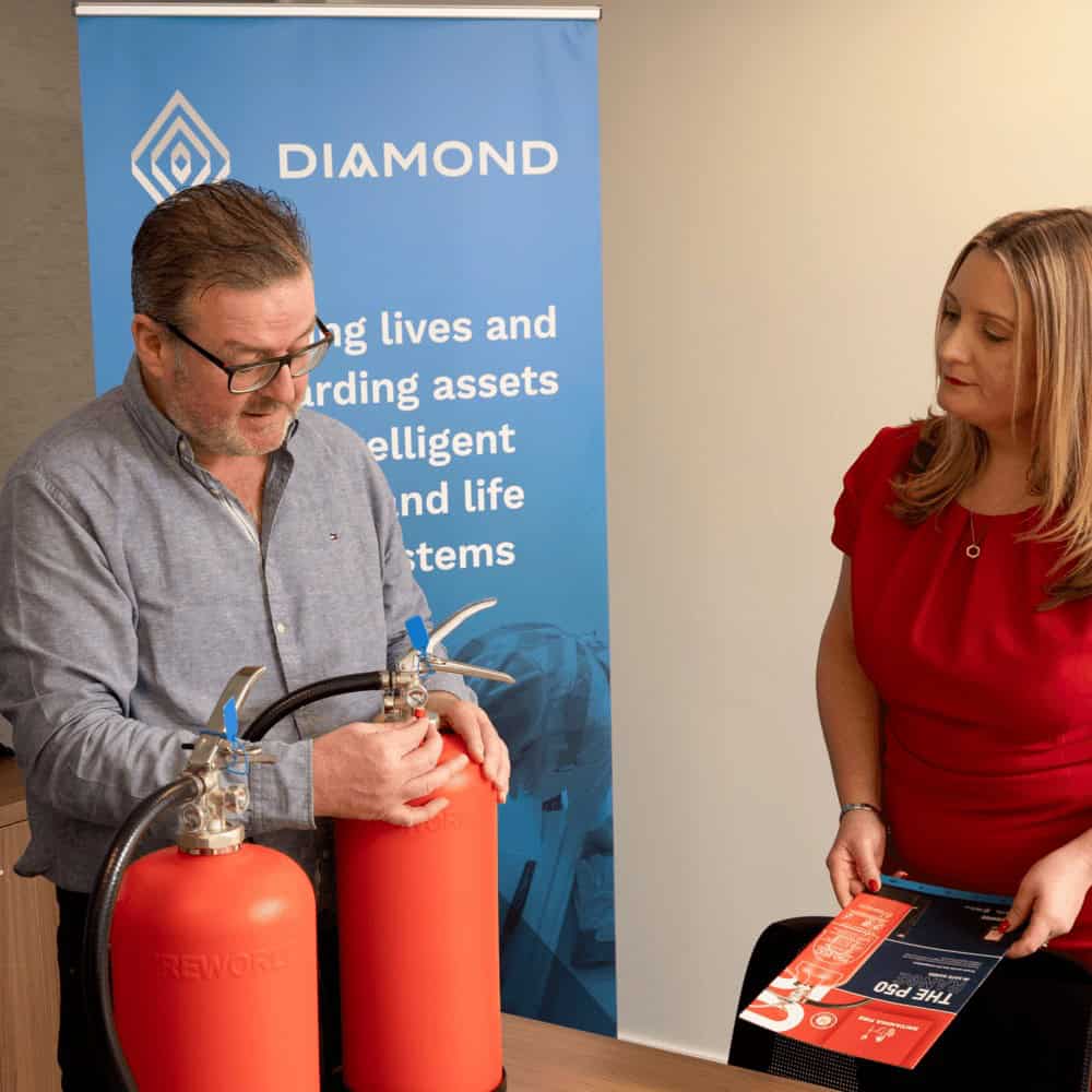 Britannia Fire representative discussing the features of a P50 fire extinguisher
