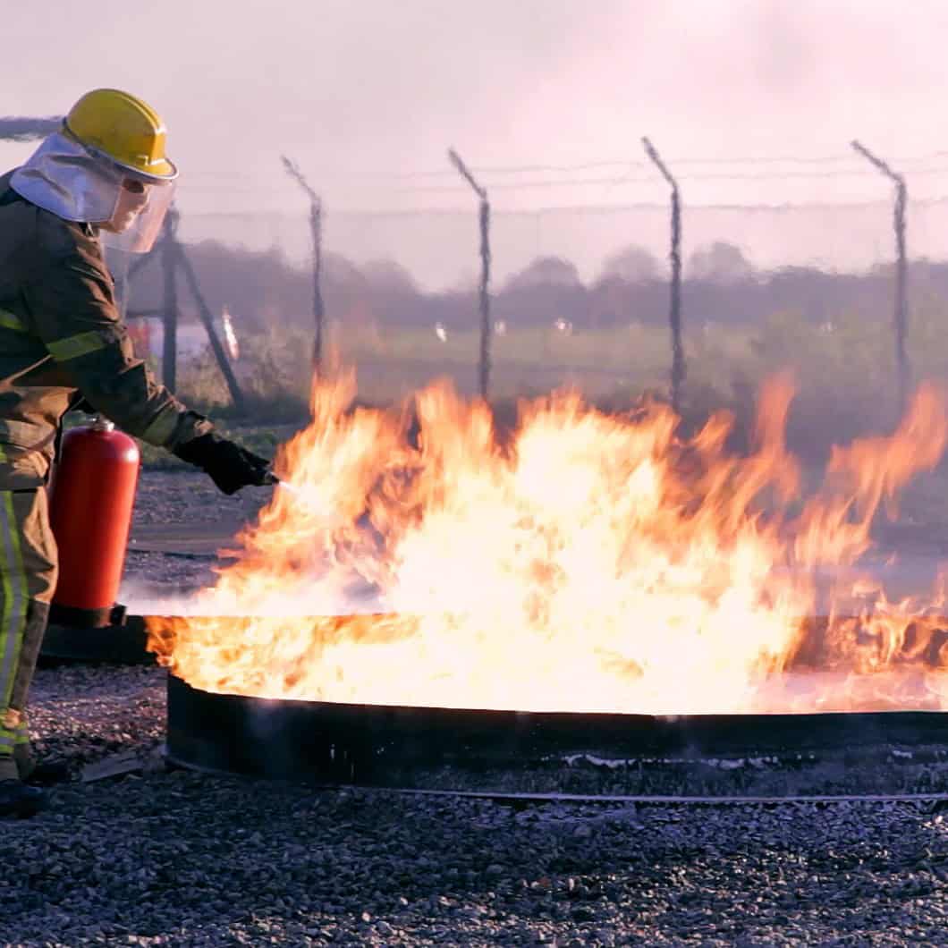 Person using a P50 fire extinguisher to put out a fire